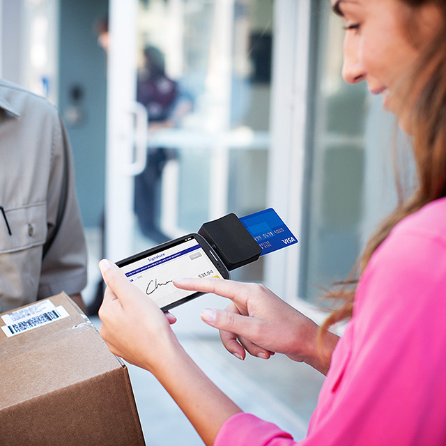 Woman paying on a tablet for a delivery
