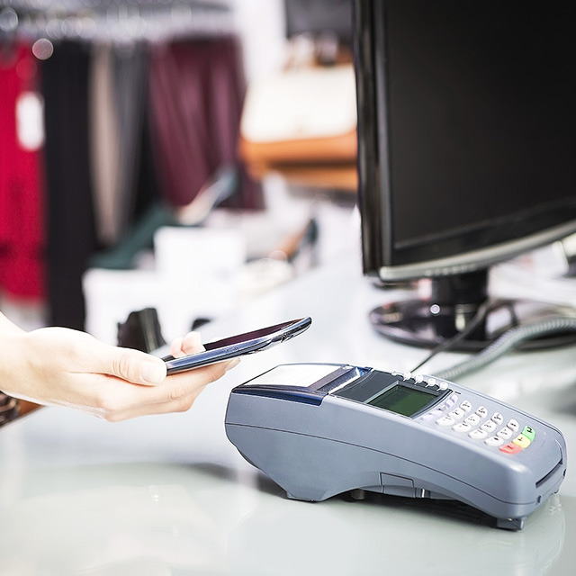 Woman using a mobile phone to pay for a transaction
