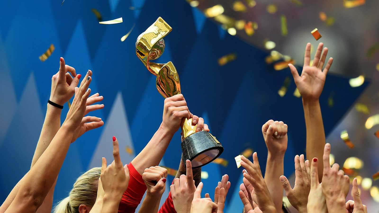 Women’s world cup trophy being held up in the air