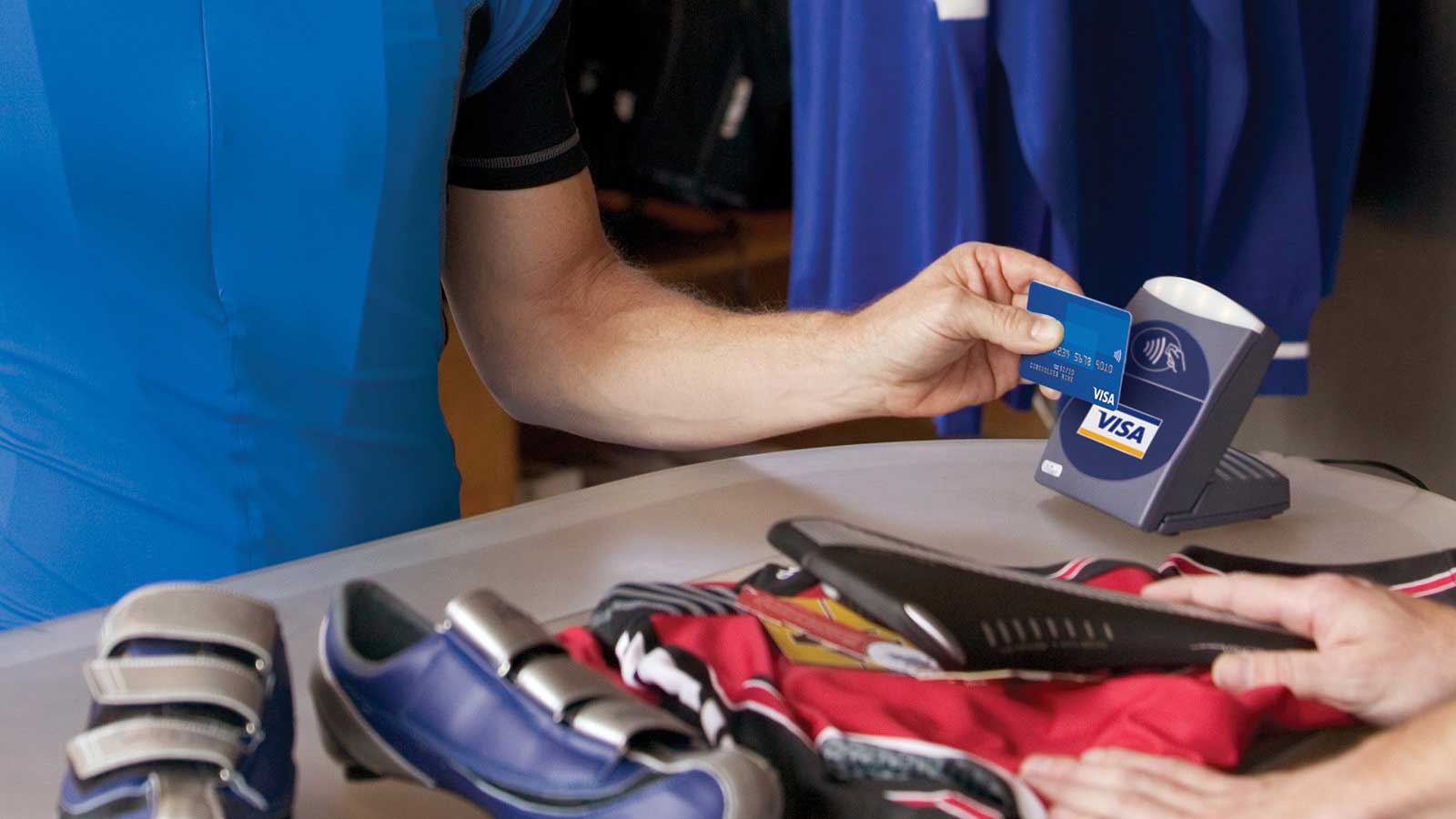 Person using Visa contactless card to pay for shoes.