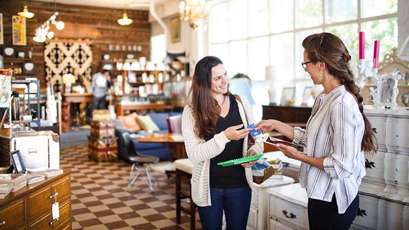 Lady paying with Visa card in a shop
