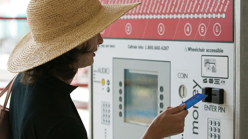 A picture of a woman using a prepaid card.