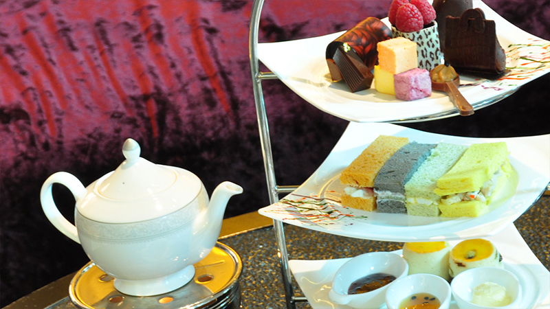 pot of tea and plates of desserts pot of tea and plates of desserts